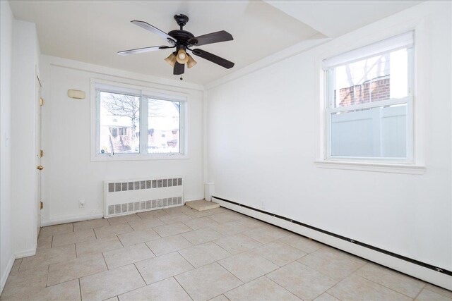 unfurnished room with plenty of natural light, ceiling fan, radiator heating unit, and baseboard heating