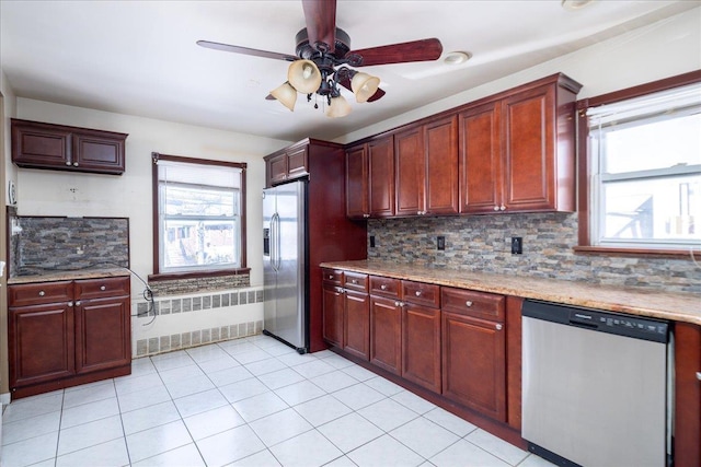 kitchen with dark brown cabinets, appliances with stainless steel finishes, backsplash, and radiator