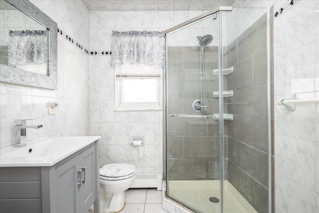 full bathroom with baseboard heating, tile patterned floors, tile walls, and a stall shower