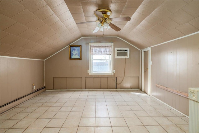 additional living space with light tile patterned floors, baseboard heating, a wall mounted AC, a ceiling fan, and vaulted ceiling