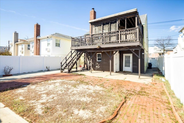 rear view of property with a fenced backyard, a patio, stairway, and a wooden deck