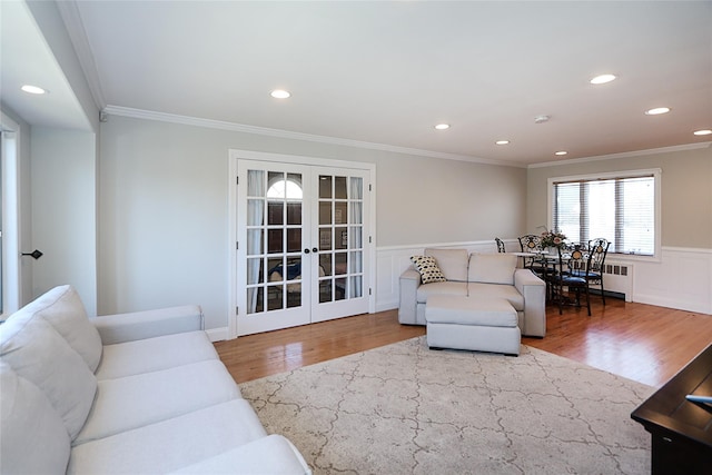 living room featuring wood finished floors, recessed lighting, french doors, wainscoting, and crown molding