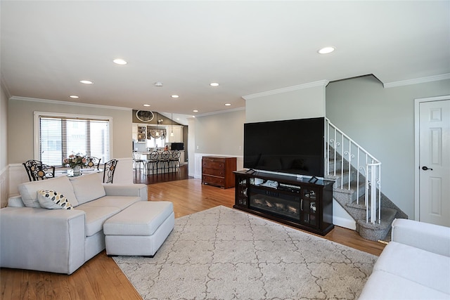 living room featuring recessed lighting, stairway, wood finished floors, and crown molding