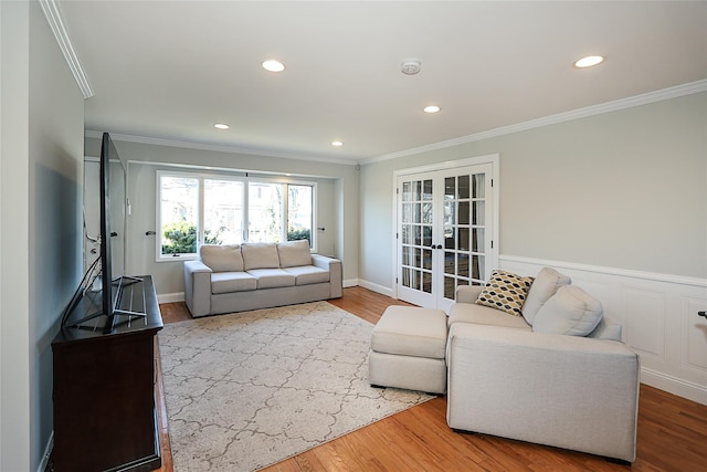 living area featuring recessed lighting, ornamental molding, french doors, and wood finished floors