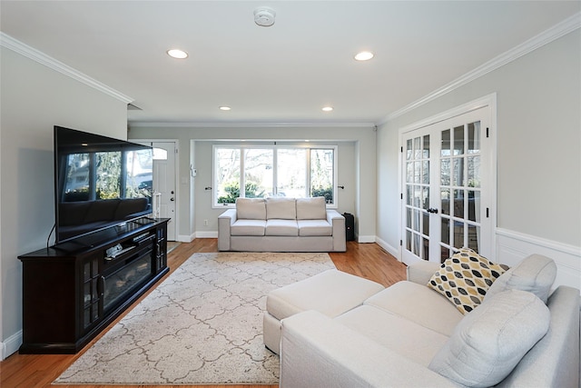 living room with recessed lighting, french doors, crown molding, and wood finished floors