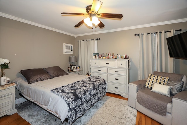 bedroom featuring ornamental molding, a wall mounted AC, ceiling fan, and wood finished floors