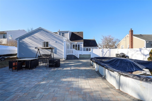 exterior space with a patio area, fence, and a gate