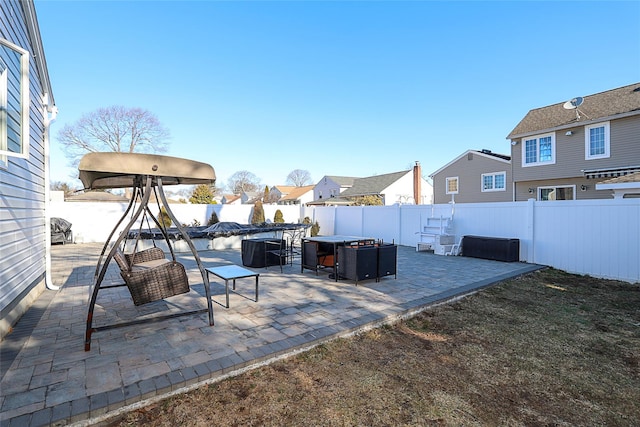 view of patio / terrace with a swimming pool, a fenced backyard, and a residential view