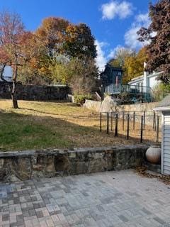 view of yard featuring fence and a patio