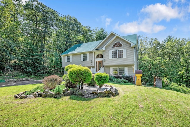 split foyer home with a front lawn