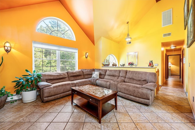 living room featuring high vaulted ceiling, light tile patterned flooring, and visible vents