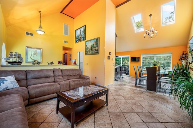 tiled living area with an inviting chandelier, vaulted ceiling with skylight, and visible vents