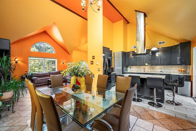 dining room featuring high vaulted ceiling, visible vents, and light tile patterned floors