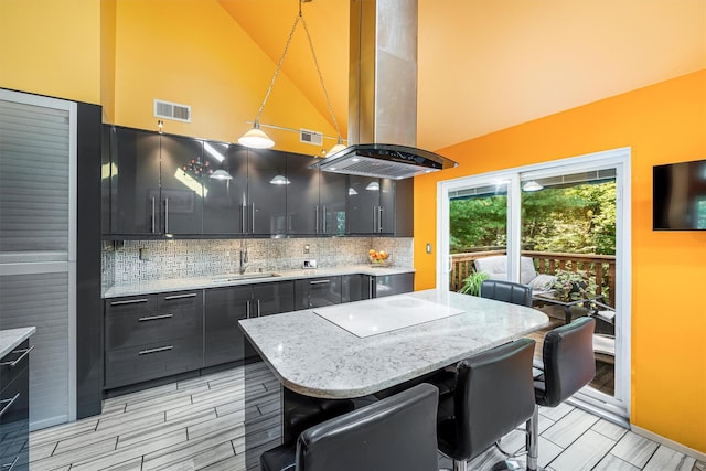 kitchen with visible vents, decorative backsplash, white electric cooktop, island exhaust hood, and a sink