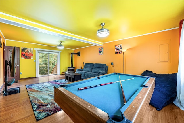 game room with pool table, a wood stove, electric panel, and wood finished floors