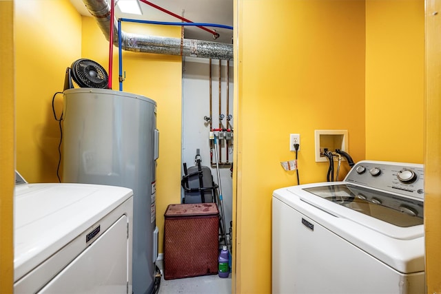 clothes washing area with water heater, laundry area, and separate washer and dryer