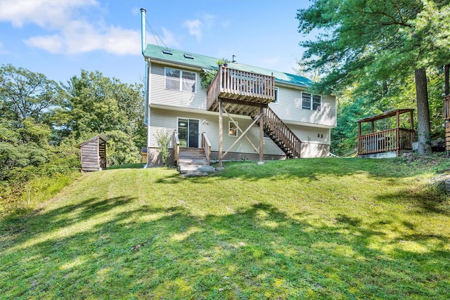 rear view of property with a yard, stairway, and a wooden deck