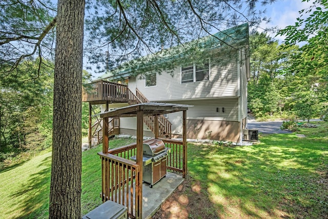 rear view of property with cooling unit, a yard, a deck, and stairs