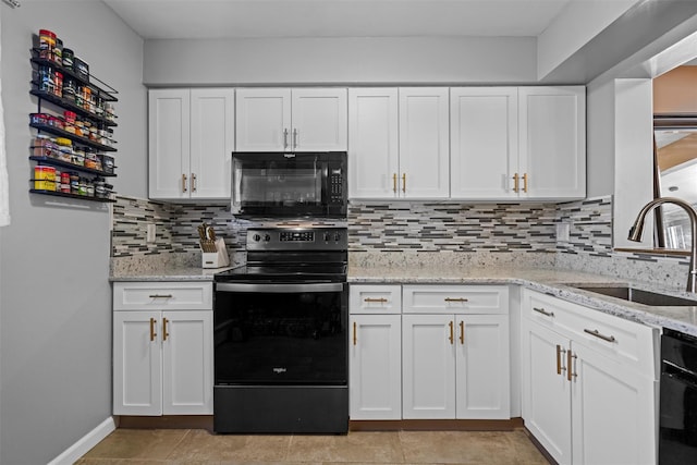 kitchen with a sink, backsplash, black appliances, and white cabinetry