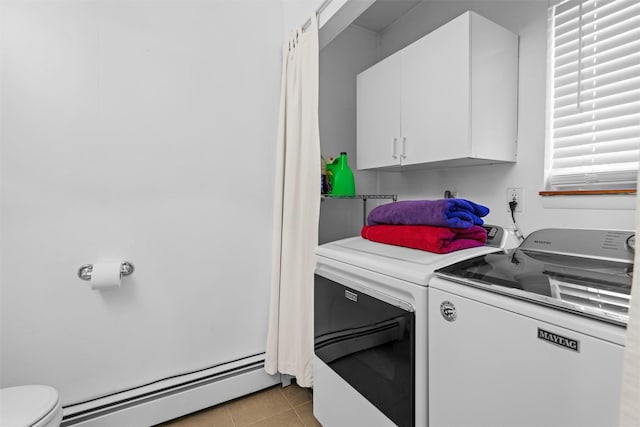 clothes washing area featuring light tile patterned floors, baseboard heating, laundry area, and washer and clothes dryer