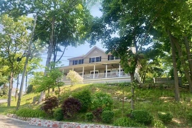 back of house featuring covered porch