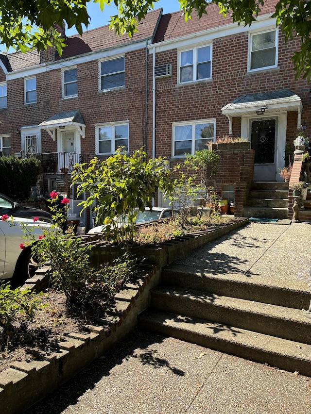 view of front of home with entry steps and brick siding