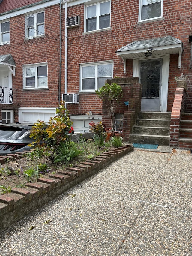 42-30 196th St, Flushing, NY 11358 - entrance to property with brick siding and a wall mounted air conditioner