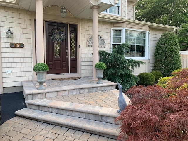 view of exterior entry with covered porch