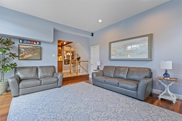 living area with recessed lighting, baseboards, and wood finished floors