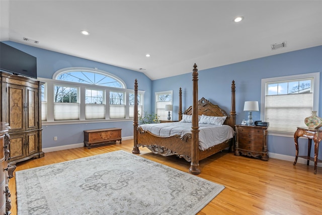 bedroom featuring visible vents, light wood finished floors, baseboards, recessed lighting, and vaulted ceiling