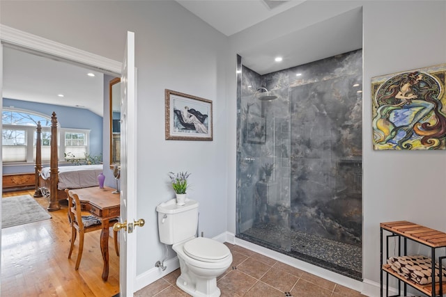 ensuite bathroom with baseboards, tile patterned flooring, ensuite bathroom, walk in shower, and toilet