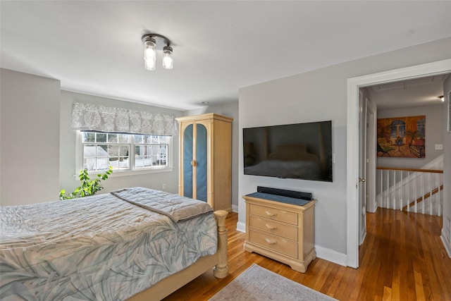 bedroom with wood finished floors and baseboards