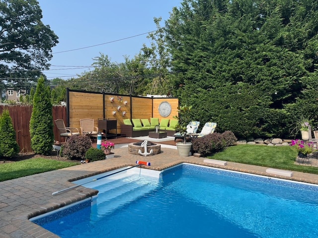 view of pool with an outdoor living space with a fire pit, a patio area, fence, and a fenced in pool