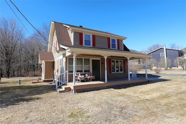 back of house with a porch and a shingled roof