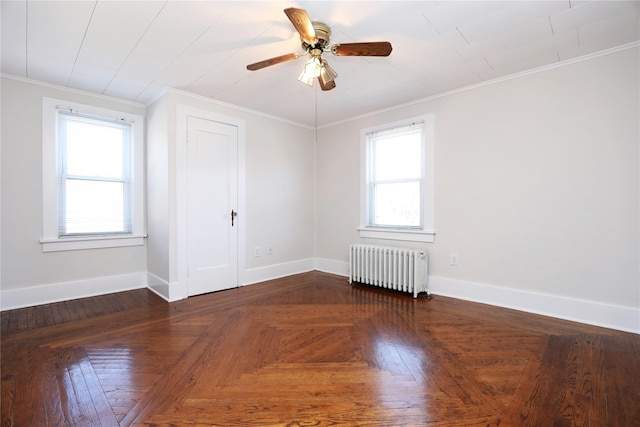 unfurnished room featuring baseboards, ornamental molding, radiator heating unit, and a healthy amount of sunlight