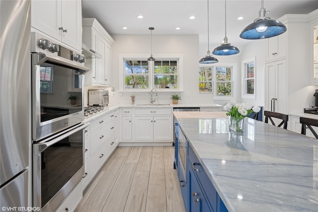 119 Cassilis Ave, Bronxville, NY 10708 - kitchen with blue cabinets, a sink, appliances with stainless steel finishes, white cabinetry, and recessed lighting