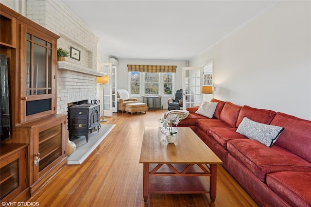119 Cassilis Ave, Bronxville, NY 10708 - living room with radiator heating unit, a wood stove, and hardwood / wood-style flooring