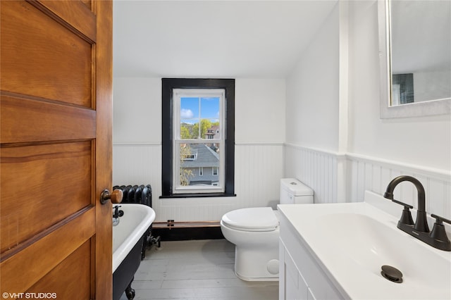 119 Cassilis Ave, Bronxville, NY 10708 - full bath featuring a wainscoted wall, a freestanding bath, toilet, vanity, and wood finished floors