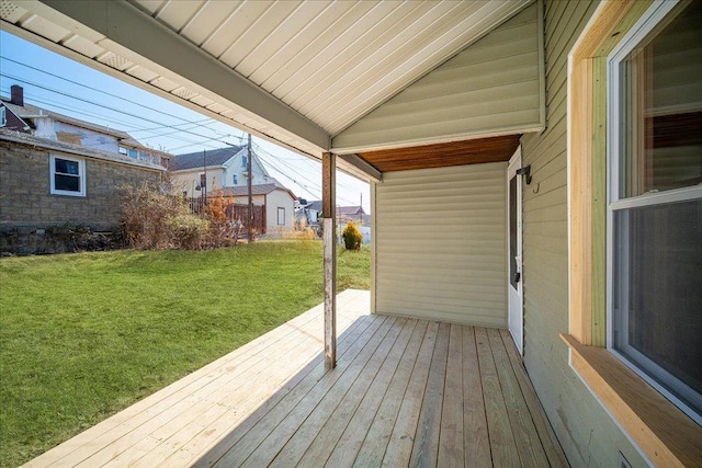 wooden deck featuring a lawn