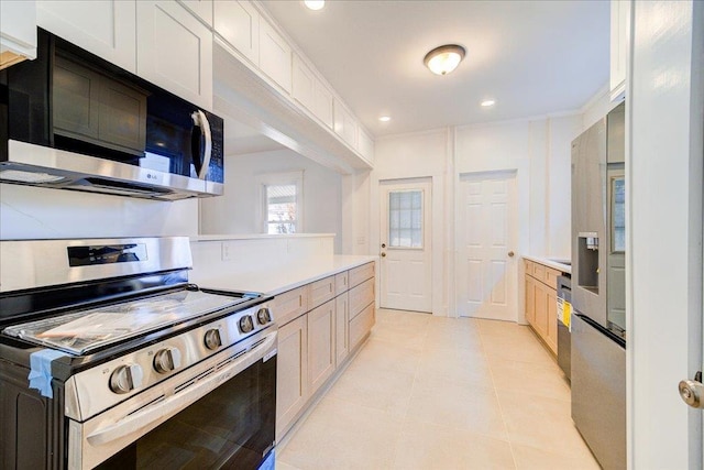 kitchen featuring white cabinetry, recessed lighting, appliances with stainless steel finishes, light countertops, and light tile patterned floors