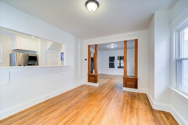 unfurnished room with light wood-style floors and baseboards