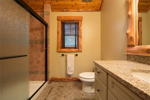 bathroom featuring toilet, a shower stall, and vanity