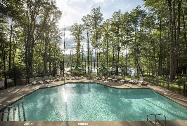 community pool featuring a patio area and fence