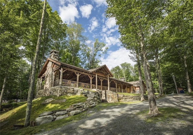 exterior space with driveway and a chimney