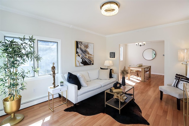 living area with ornamental molding, light wood-type flooring, and baseboard heating