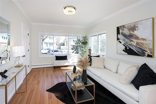 living room with crown molding, baseboard heating, and wood finished floors