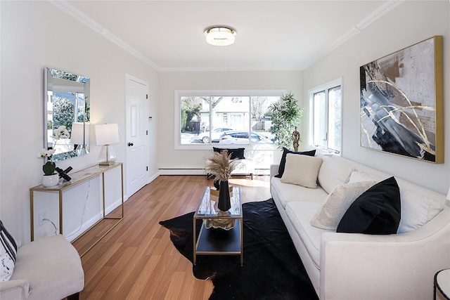 living area featuring ornamental molding, a baseboard radiator, baseboards, and wood finished floors