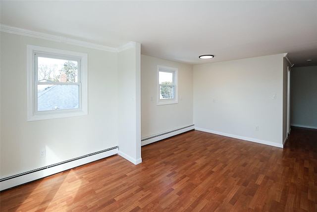 unfurnished room featuring baseboards, a baseboard heating unit, wood finished floors, and ornamental molding