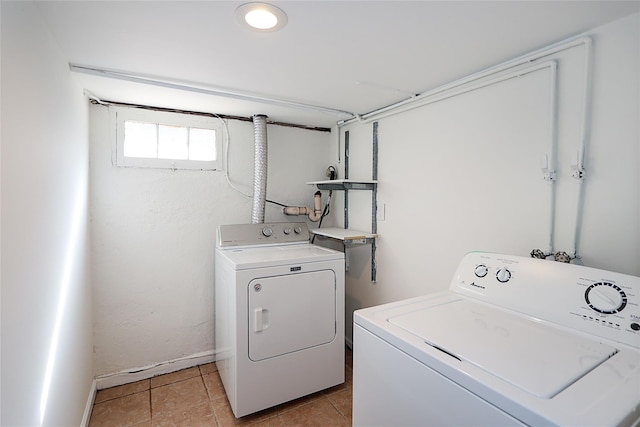 clothes washing area featuring laundry area, independent washer and dryer, and light tile patterned floors