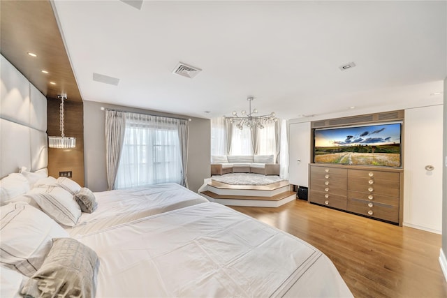 bedroom featuring a notable chandelier, recessed lighting, visible vents, and wood finished floors